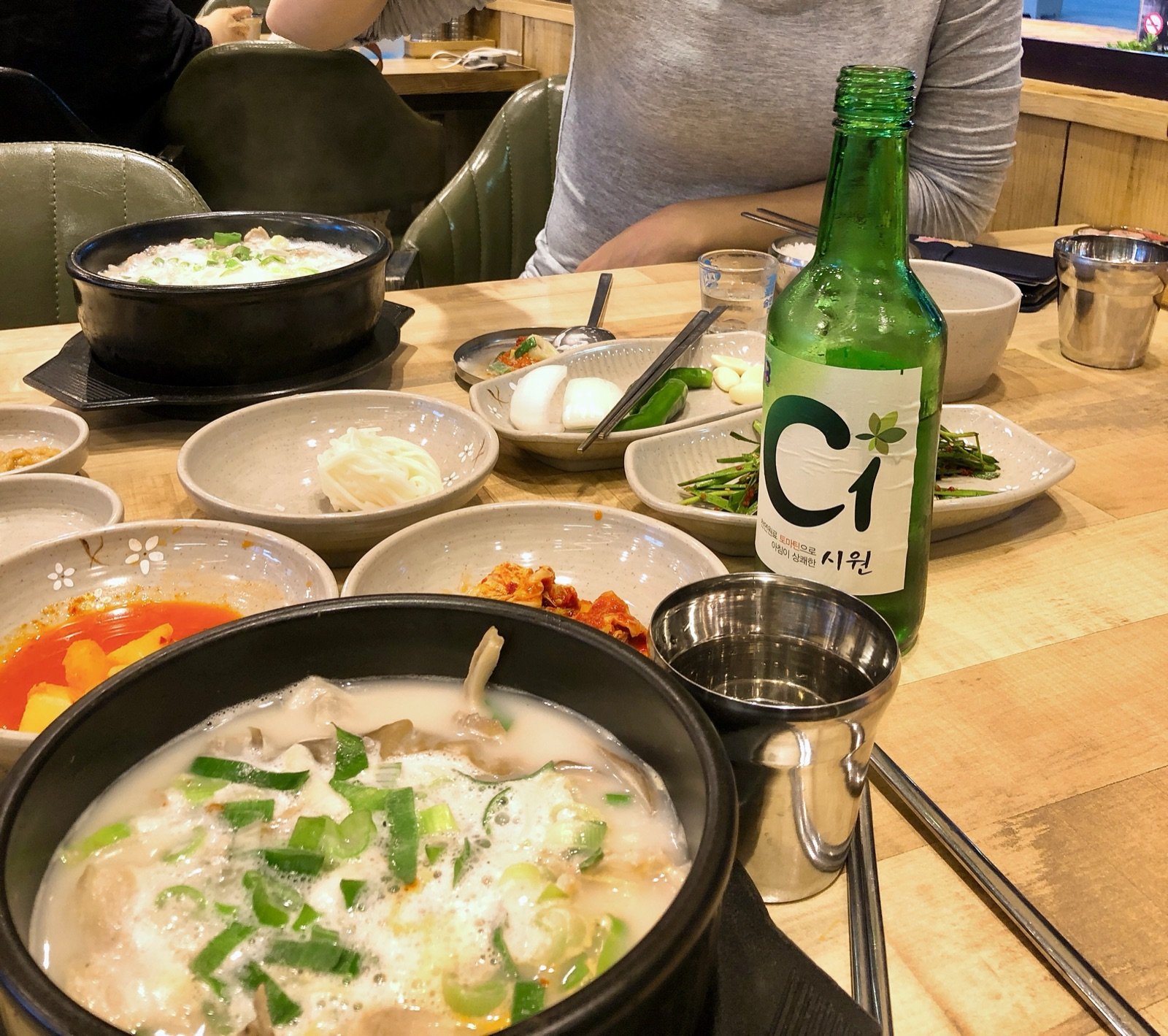 C1 regional soju served with pork soup and side dishes at a Korean restaurant