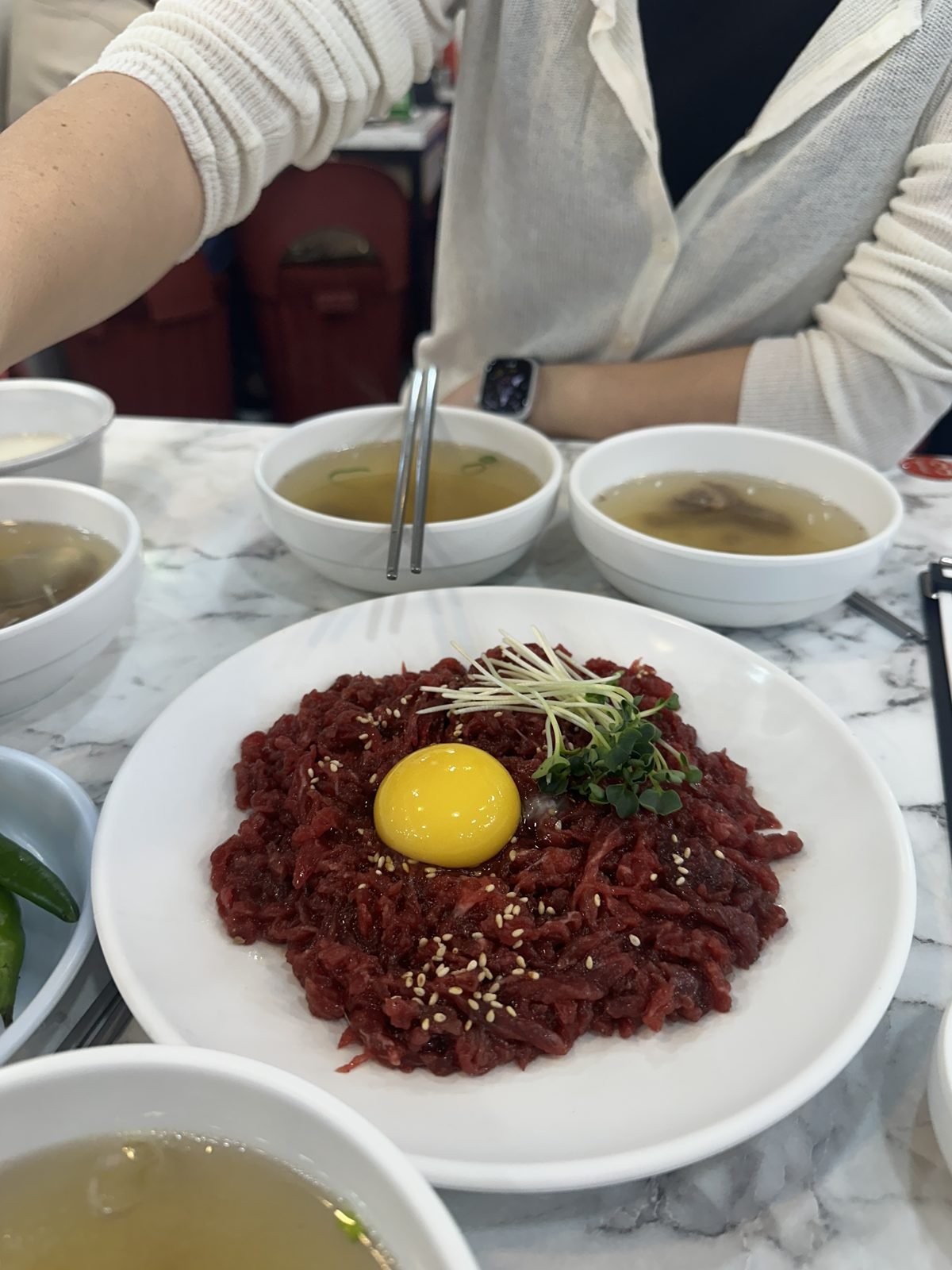 A plate of yukhoe raw beef with an egg yolk at Gwangjang Market