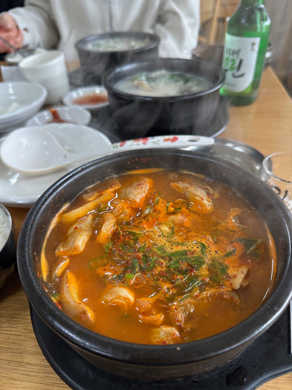 Steaming spicy Korean soup served with soju as anju