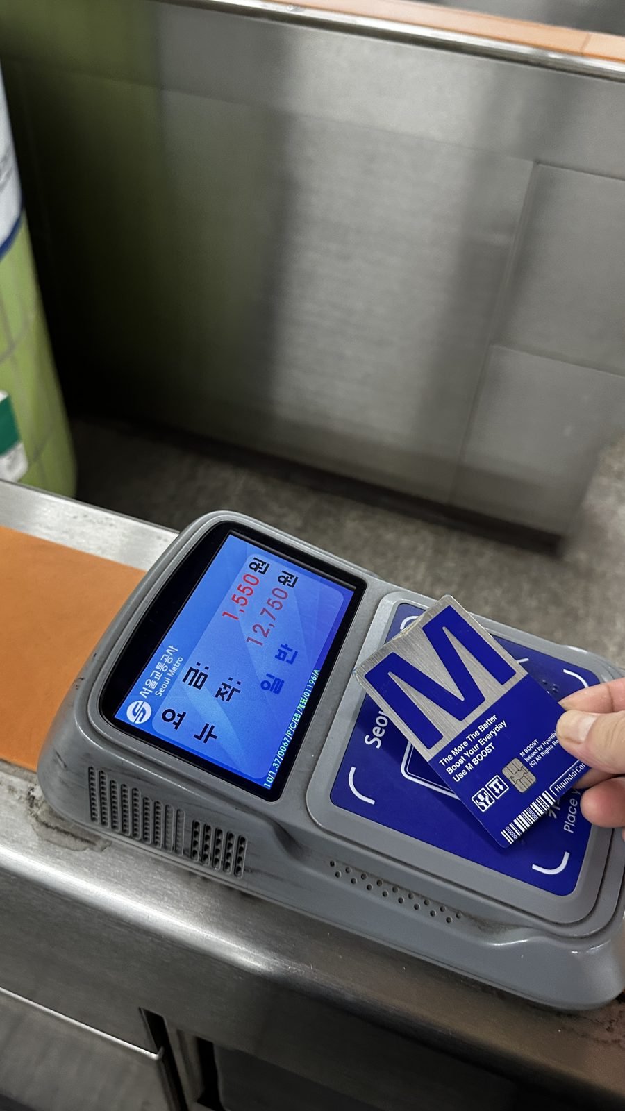 Blue transit-card reader at a Seoul subway gate