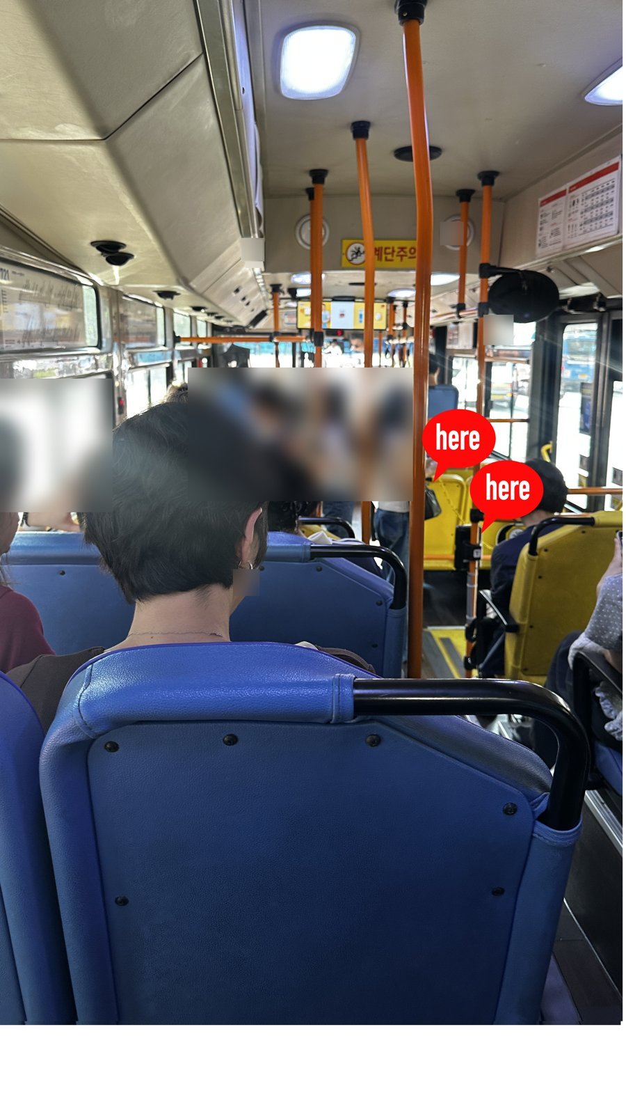 Two card readers by the rear door of a Seoul city bus, marked where to tap when getting off